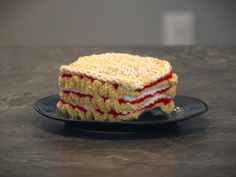 a crocheted cake sitting on top of a black plate