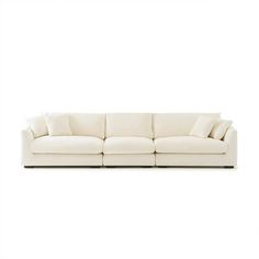 a white couch with pillows on top of it