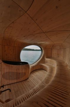 the inside of a wooden boat looking out at water