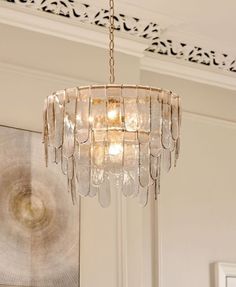 a chandelier hanging from the ceiling in a room