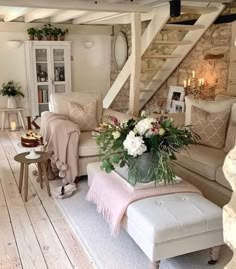 a living room filled with furniture and flowers