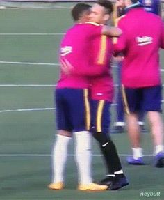 two soccer players are hugging each other on the field