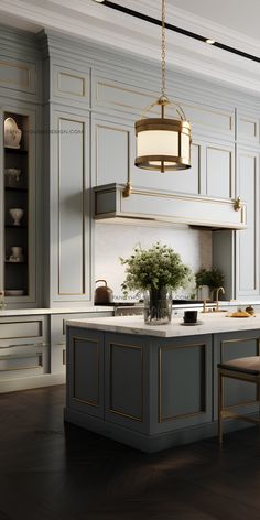 a large kitchen with an island in the middle and gold trimmings on the cabinets