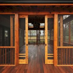 an open porch with wooden flooring and sliding glass doors