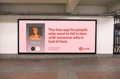 a subway station with a large advertisement on the wall