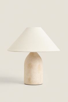 a white lamp sitting on top of a table