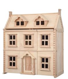 a wooden doll house with windows and doors