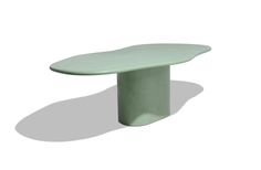 an oval shaped table sitting on top of a white floor