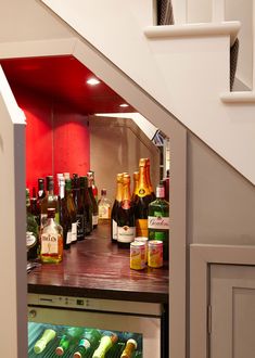 an under stair case filled with lots of bottles