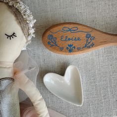 Our petite beechwood baby hairbrush is soft to the touch and the perfect gift for a baby or toddler. It is crafted with natural wood and gentle goat hair bristles. It measures approximately 7 inches in length. This sweet blue bow and floral design is a studio favorite! This design is also available in pink. Personalize your brush with your child's name and a meaningful detail (a date, initial or age) to mark the occasion! A thoughtful and one-of-a-kind gift for a new baby, baby shower, first birthday, baby's first Christmas, Christening and more.  Care: Our petite beechwood baby hairbrush is hand painted and lacquered with a matte varnish to protect the design. Please clean by wiping gently with a damp cloth. Disclaimer:  Due to the hand painted personalization and natural wood brushes use Cadeau Baby Shower, Goat Hair, New Baby Gift, Blue Bow, Floral Baby, Babies First Christmas, Baby Baby, New Baby Gifts, Baby Shower Gift