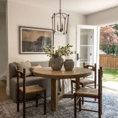 a living room with a couch, table and chairs