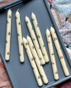 several candles are lined up on a tray