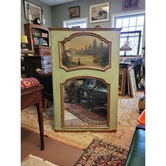 an antique painting is on display in the corner of a room with other furniture and decor