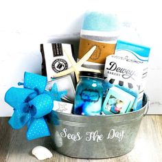 a bucket filled with assorted items on top of a wooden table next to a starfish