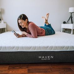 a woman laying on top of a haven mattress