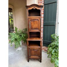 an old fashioned wooden cabinet sitting outside