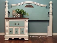 a white dresser sitting next to a blue wall with a plant on top of it