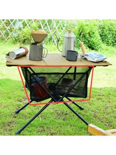 a table with some cups on it in the grass