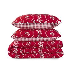 three red and white pillows stacked on top of each other