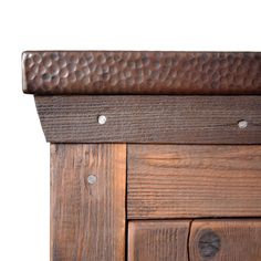 a close up view of a wooden cabinet with metal knobs on the top and bottom