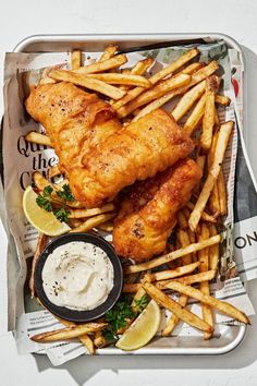 chicken and french fries in a tray with dipping sauce