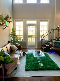 a living room filled with furniture and a green rug