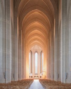 the inside of a church with rows of pews lined up against the wall and windows