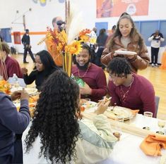 a group of people sitting around a table eating food