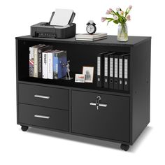 a black bookcase with two drawers and a printer on the top, next to some books