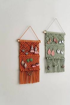 two wall hangings with beads and tassels on them