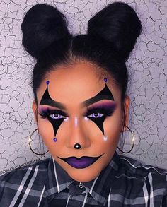 a woman with black and purple makeup has her face painted to look like a cat