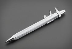 a silver pen on a gray surface