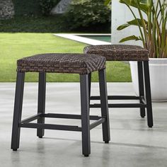 two stools sitting next to each other on a patio