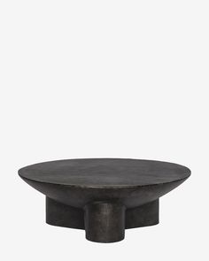 a round black table with an iron base on the top, against a white background