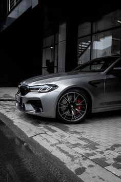 a silver car parked in front of a building