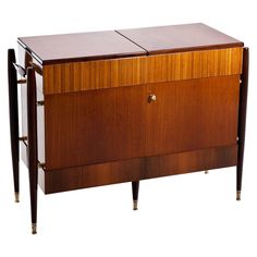 an art deco sideboard with two doors and three drawers on the front, one door open