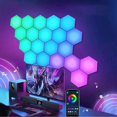 a desk with a monitor, keyboard and mouse next to it is an image of hexagon cubes on the wall