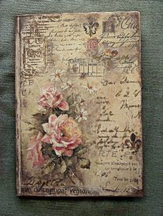 an old postcard with roses on it is hanging on the wall in front of a green background