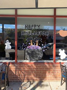 a store front with halloween decorations in the window