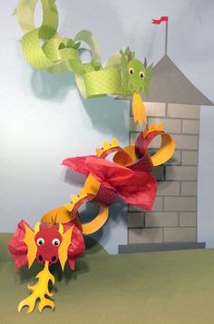 a paper sculpture of two sea creatures in front of a house