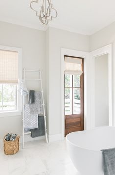 a large white bath tub sitting next to a doorway