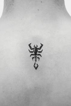 a black and white photo of a man's back with a scorpion tattoo on it