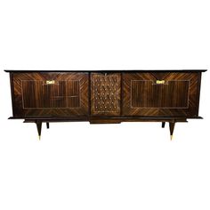 an art deco sideboard with two doors and three drawers