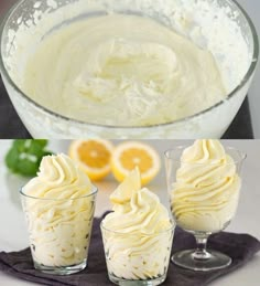 three glasses filled with whipped cream sitting on top of a table next to an orange slice