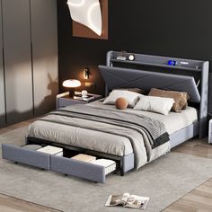 a bedroom with a bed, nightstands and an open drawer on the floor next to it