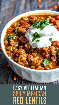 easy vegetarian spicy mexican red lentils in a white bowl with sour cream on top