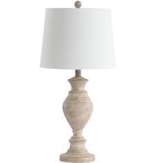 a white table lamp with a beige shade on the base and a white linen lampshade