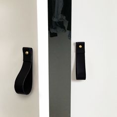 two black handles are on the white doors