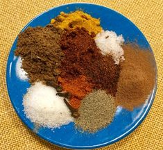 a blue plate topped with different types of spices