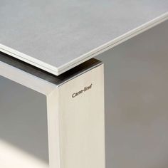 a close up of a table with a metal edge